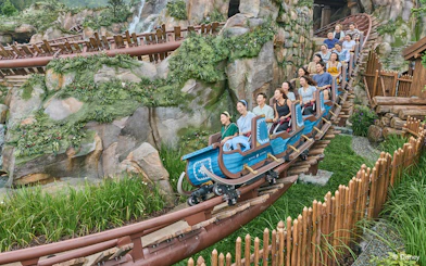 Roller coaster ride at Frozen Ever After, Disneyland Hong Kong, with passengers enjoying the thrill.
