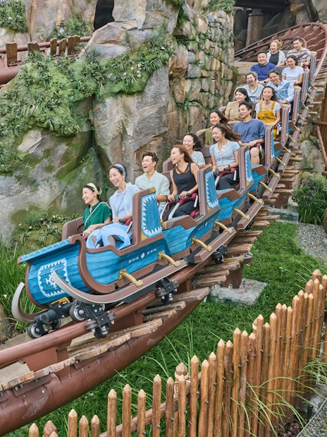 Roller coaster ride at Frozen Ever After, Disneyland Hong Kong, with passengers enjoying the thrill.
