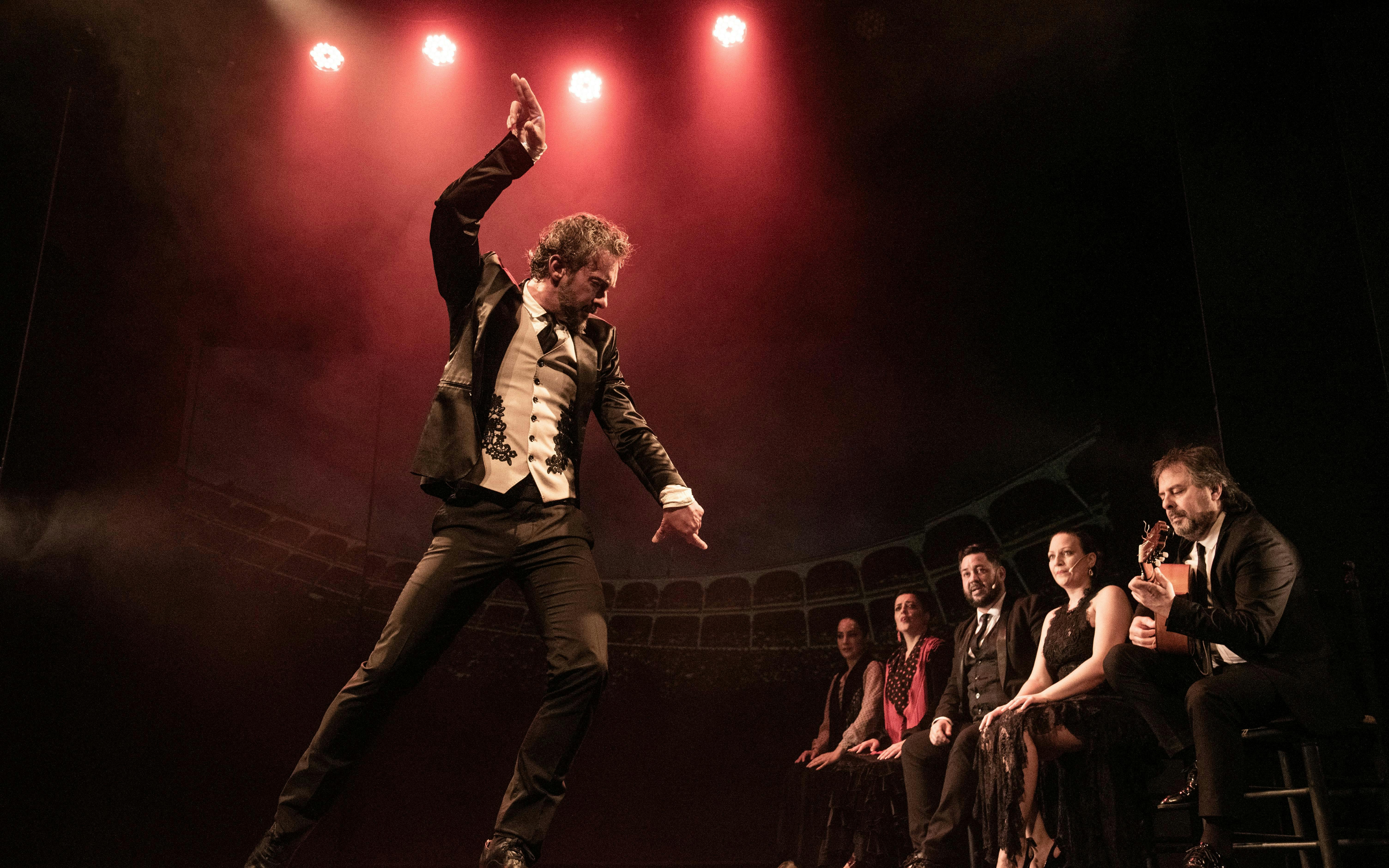 Flamenco dancer performing at Teatro Flamenco Madrid with musicians on stage.