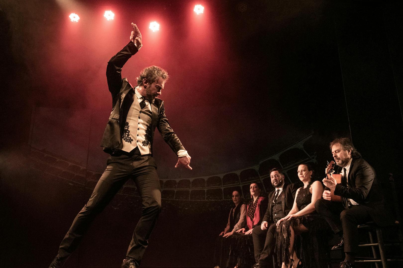 Flamenco dancer performing at Teatro Flamenco Madrid with musicians on stage.