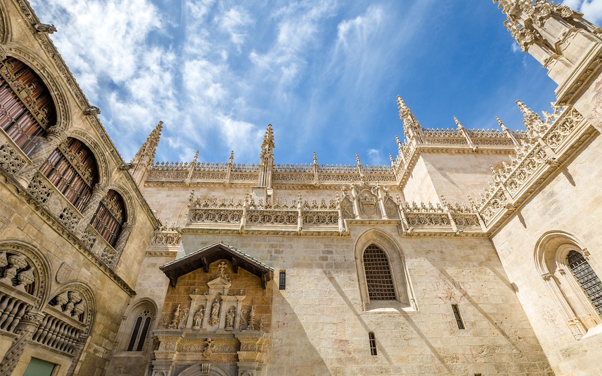 Granada Royal Chapel exterior with ornate Gothic architecture under a blue sky.