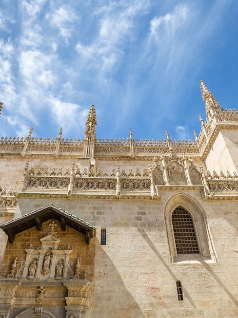 Granada Royal Chapel exterior with ornate Gothic architecture under a blue sky.
