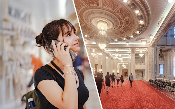 Tourist with audio guide and group exploring ornate palace interior.