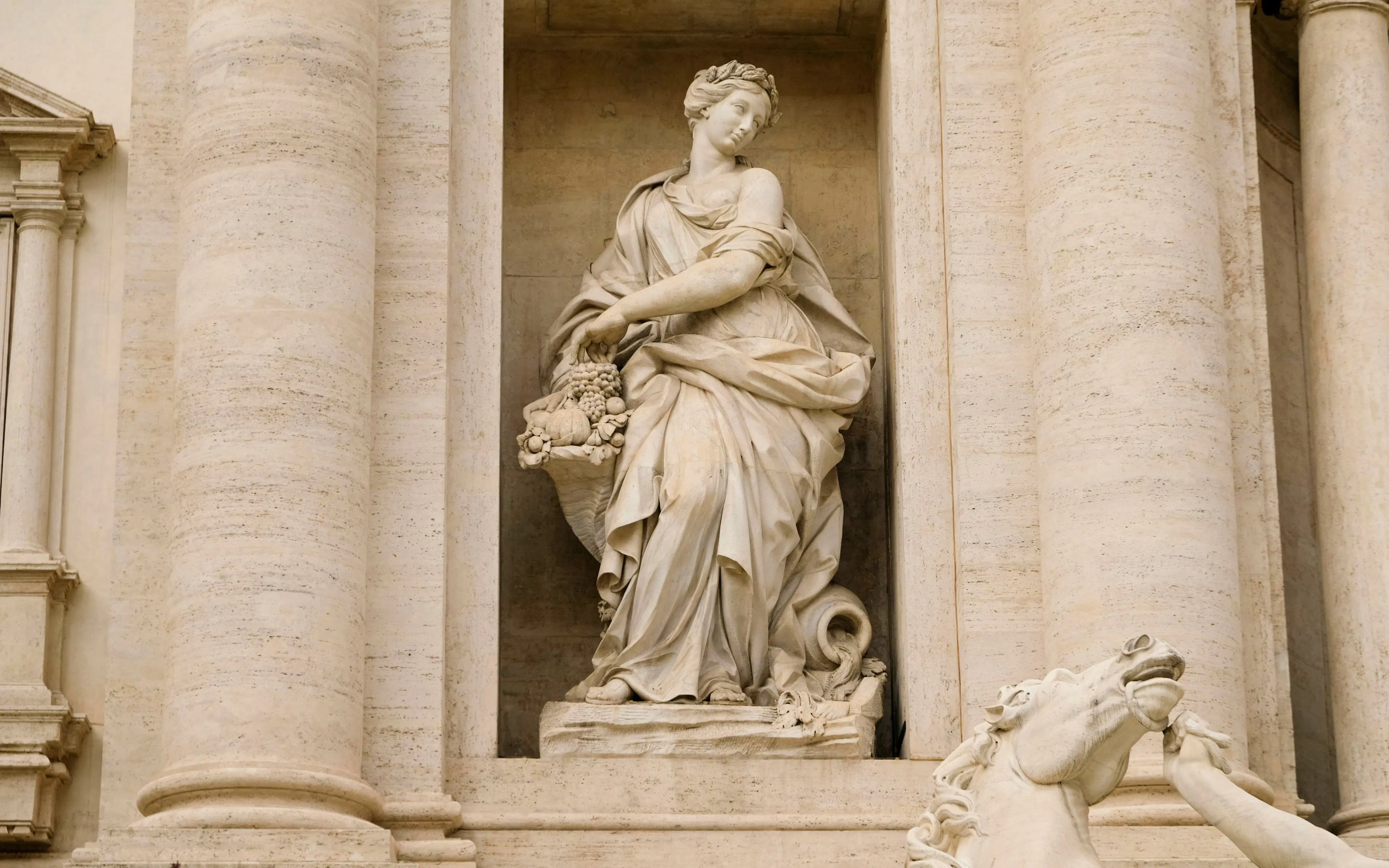 Statue of Abundance at Trevi Fountain, Rome, depicting a figure with a cornucopia.