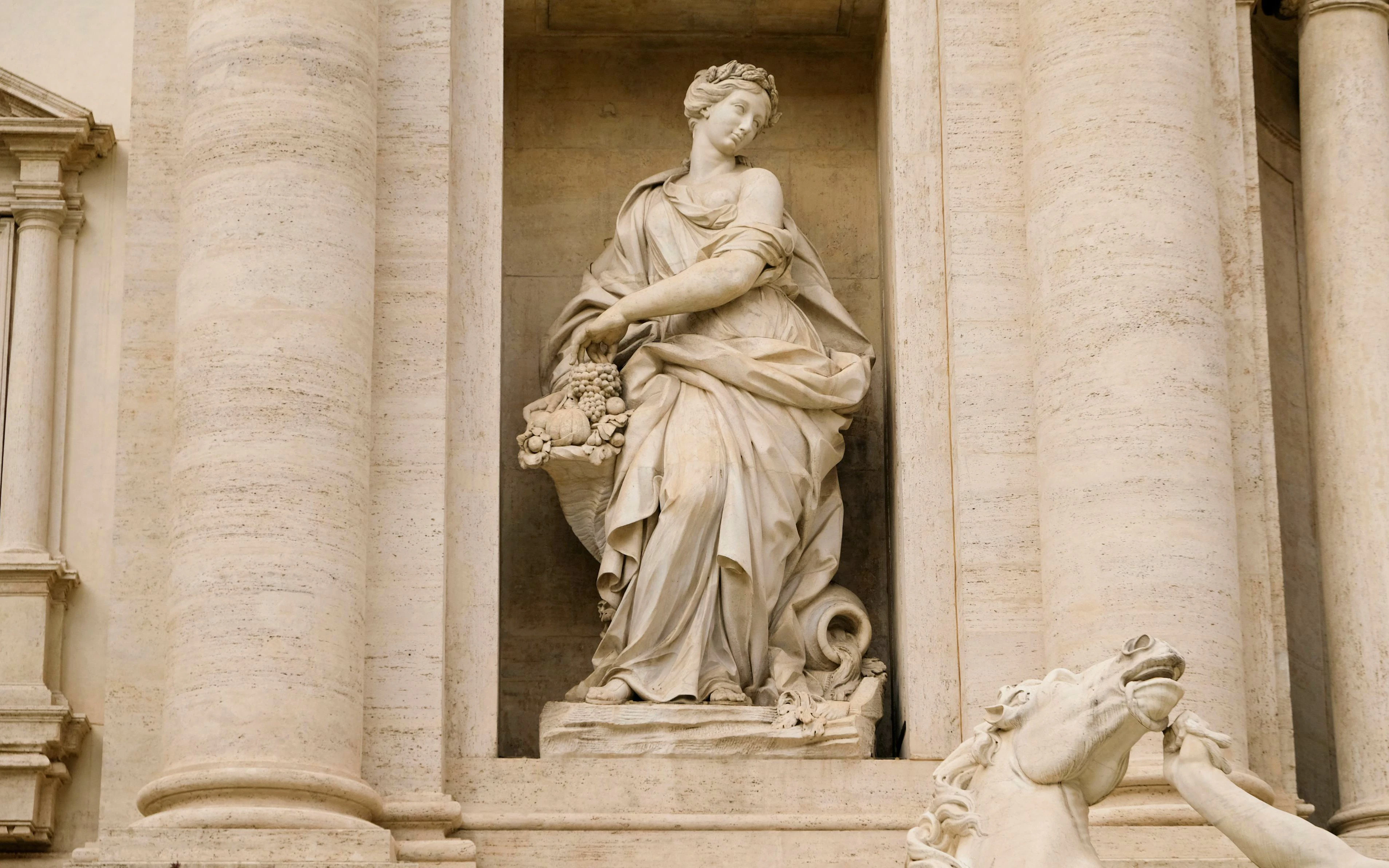 Statue of Abundance at Trevi Fountain, Rome, depicting a figure with a cornucopia.