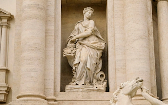 Statue of Abundance at Trevi Fountain, Rome, depicting a figure with a cornucopia.