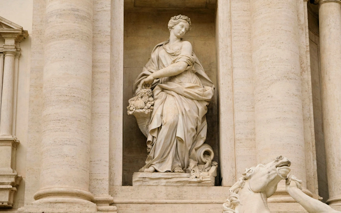 Statue of Abundance at Trevi Fountain, Rome, depicting a figure with a cornucopia.