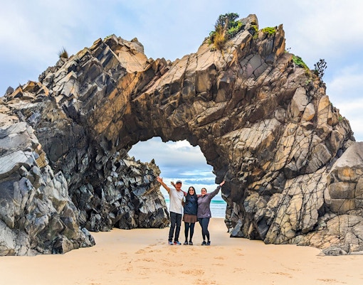 Tourists on Bruny Island nature trail exploring coastal scenery and enjoying local food tastings.