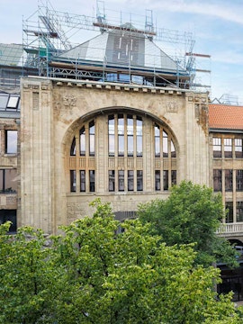 Historic building facade of Fotografiska museum in Berlin with scaffolding.