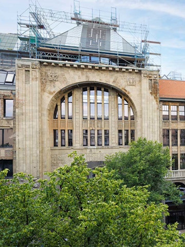 Historic building facade of Fotografiska museum in Berlin with scaffolding.
