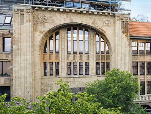 Historic building facade of Fotografiska museum in Berlin with scaffolding.