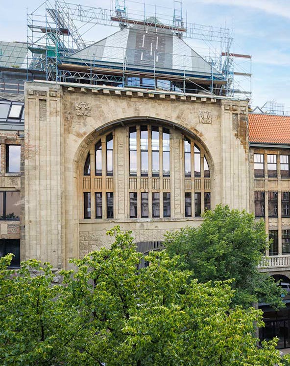 Historic building facade of Fotografiska museum in Berlin with scaffolding.