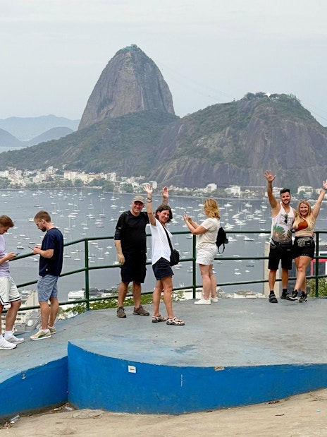 Tourists with guide at viewpoint overlooking Sugarloaf Mountain in Santa Marta, Rio de Janeiro.
