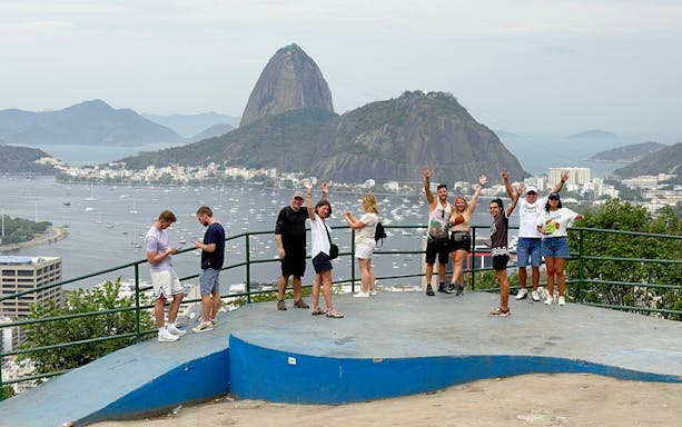 Tourists with guide at viewpoint overlooking Sugarloaf Mountain in Santa Marta, Rio de Janeiro.