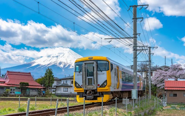 Train passing with Mt. Fuji in the background, Japan.
