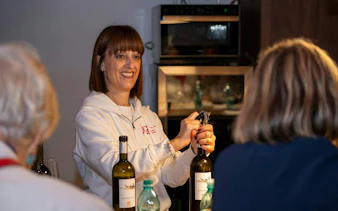 Opening wine bottle during Serdiana winery tour in Cagliari.