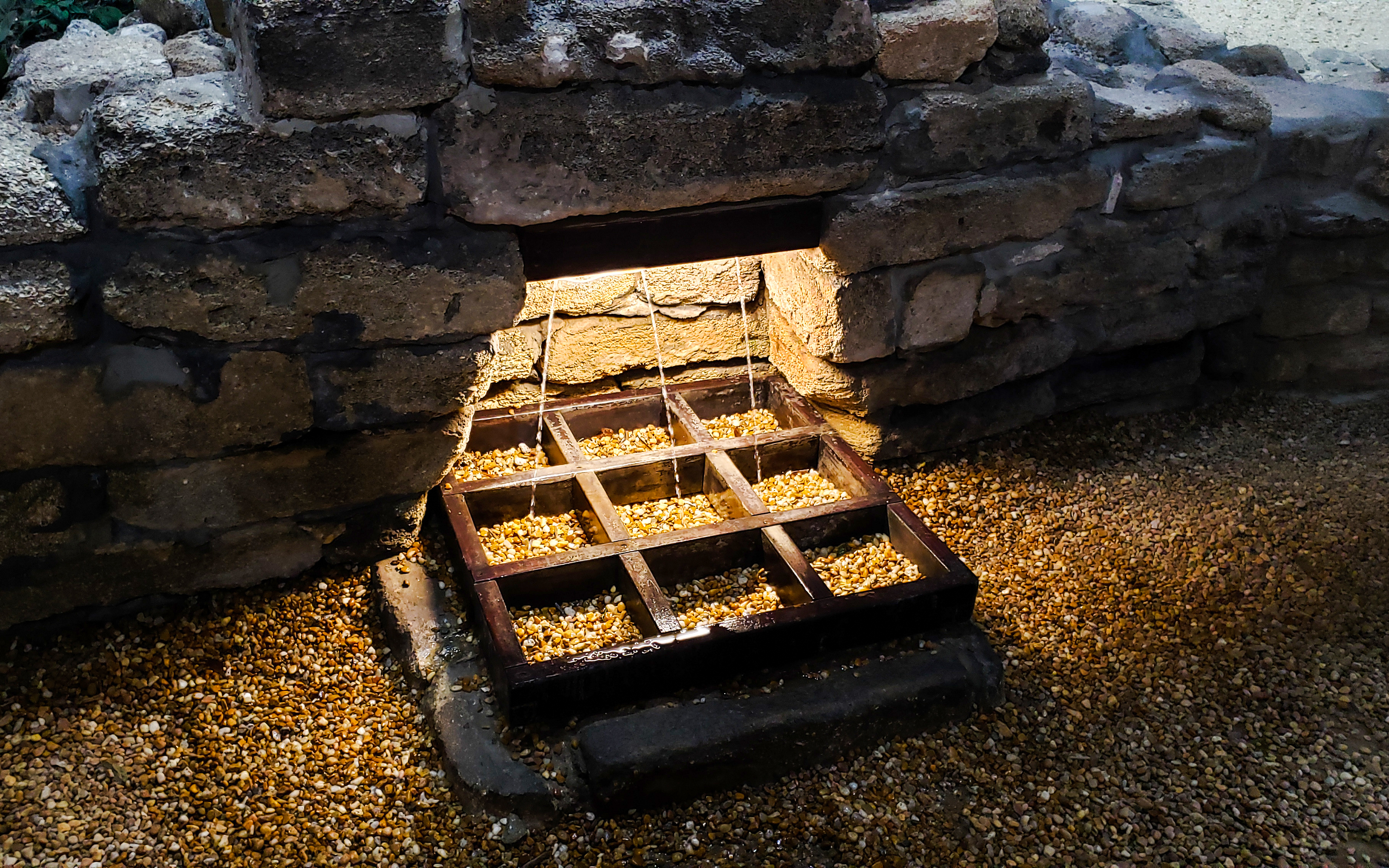 Fountain of Youth spring with water flowing through stone structure, St Augustine, Florida.