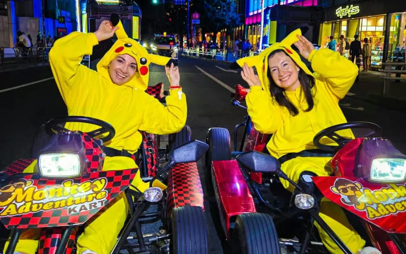 Go-kart riders in Pikachu costumes on Dotonbori street during Monkey Kart tour.