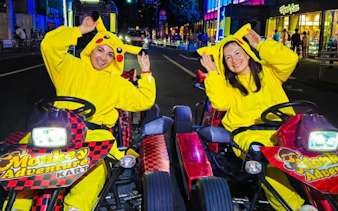 Go-kart riders in Pikachu costumes on Dotonbori street during Monkey Kart tour.