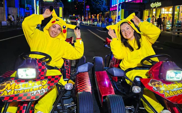 Go-kart riders in Pikachu costumes on Dotonbori street during Monkey Kart tour.