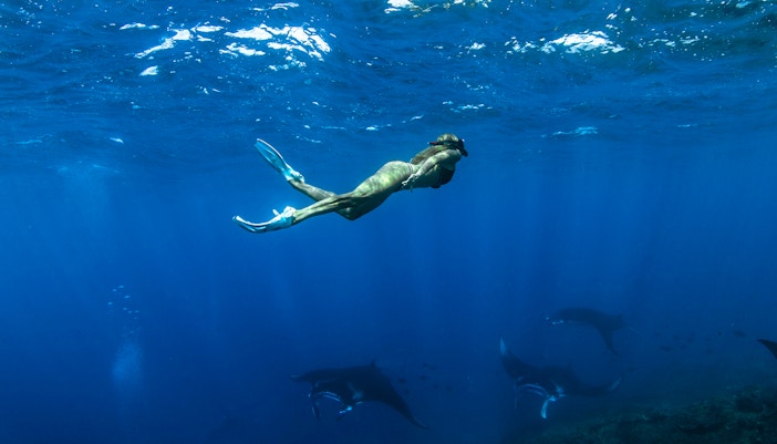 Girl snorkeling among marine life at Nusa Penida Gamat Bay, Indonesia.