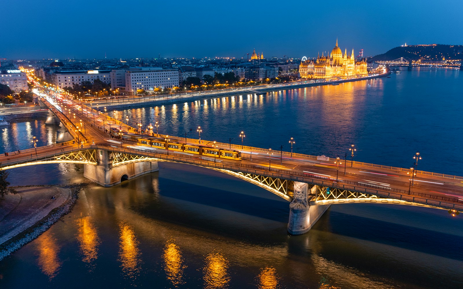 Margaret Bridge over Danube River, Budapest cityscape in background.