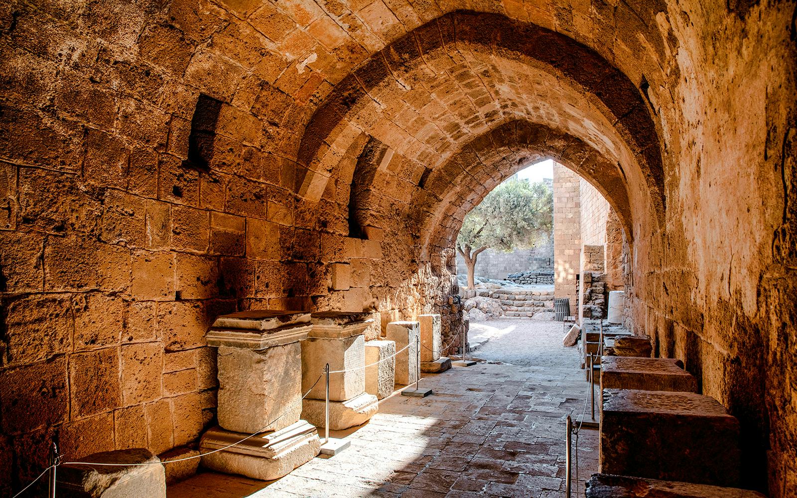 Ancient stone archway and ruins at Lindos Acropolis, Rhodes, Greece.