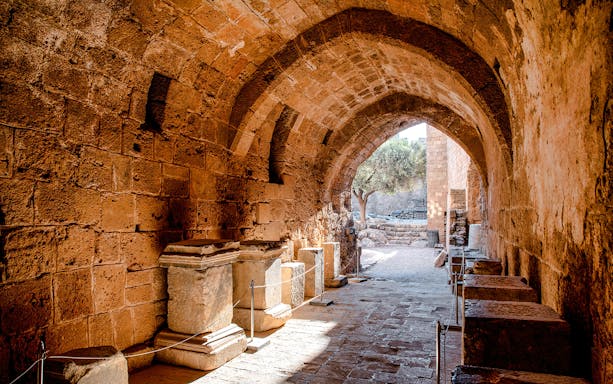 Ancient stone archway and ruins at Lindos Acropolis, Rhodes, Greece.