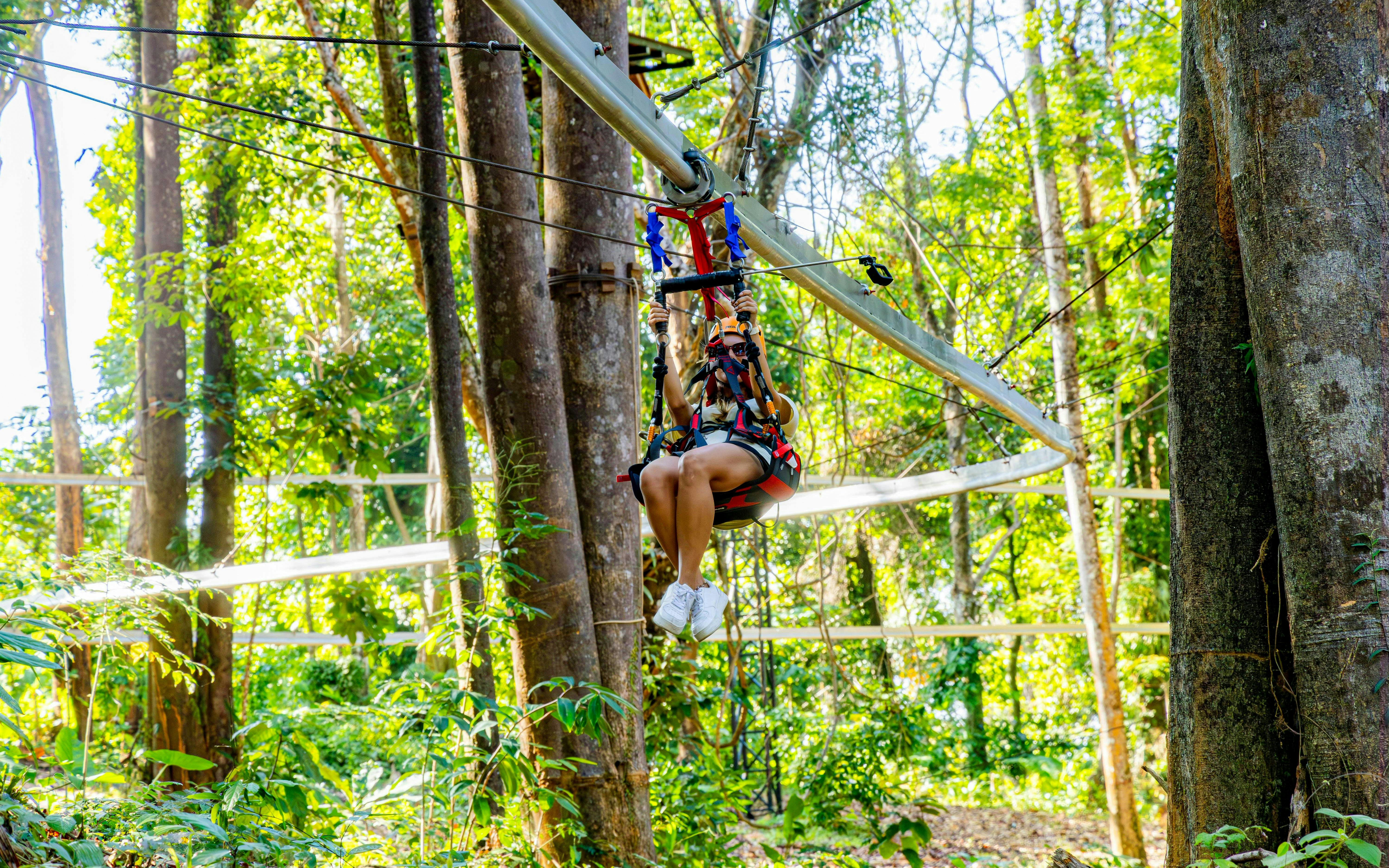 Person ziplining through forest on Sky Rock Roller Adventure in Khao Lak.