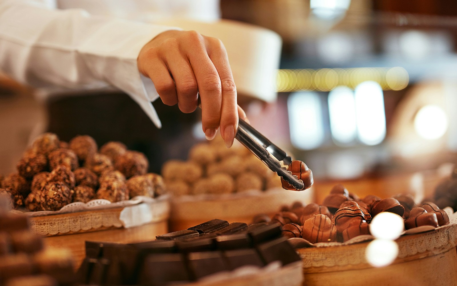Hand selecting chocolates at Chocolate Museum Cologne.