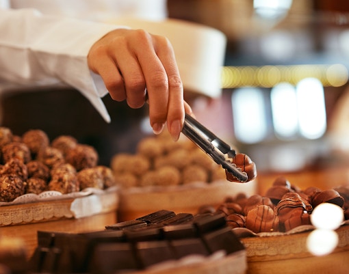 Hand selecting chocolates at Chocolate Museum Cologne.