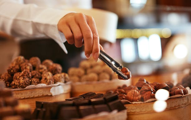 Hand selecting chocolates at Chocolate Museum Cologne.
