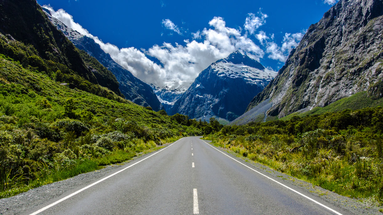 Milford Road with mountains and lush greenery in New Zealand.