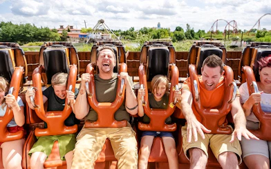Guests on a thrill ride at BELANTIS Adventure Park, Germany, enjoying the experience.