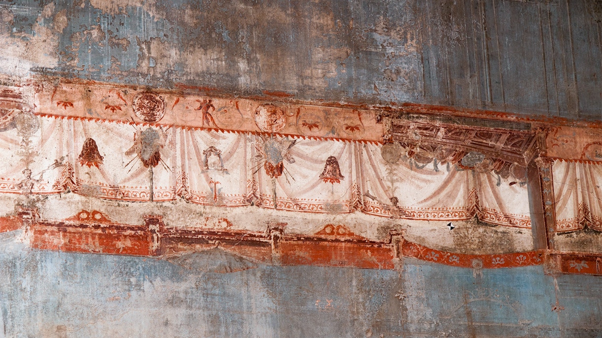 Tourist observing Frescoes at Herculaneum
