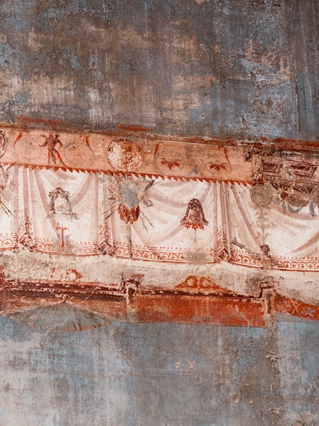 Herculaneum frescoes with detailed red and white drapery patterns.