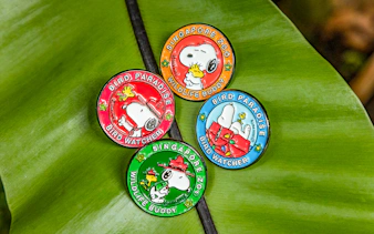 Snoopy Beagle Scouts badges from Singapore Zoo and Bird Paradise on a leaf.
