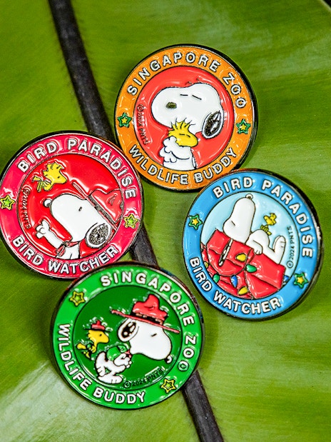 Snoopy Beagle Scouts badges from Singapore Zoo and Bird Paradise on a leaf.