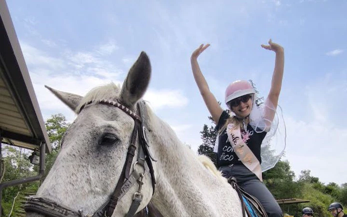 Horseback rider enjoying Tuscany countryside with views of San Gimignano.