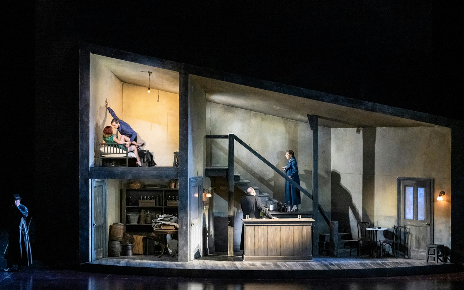 Opera scene from Rigoletto with actors on a multi-level stage set.