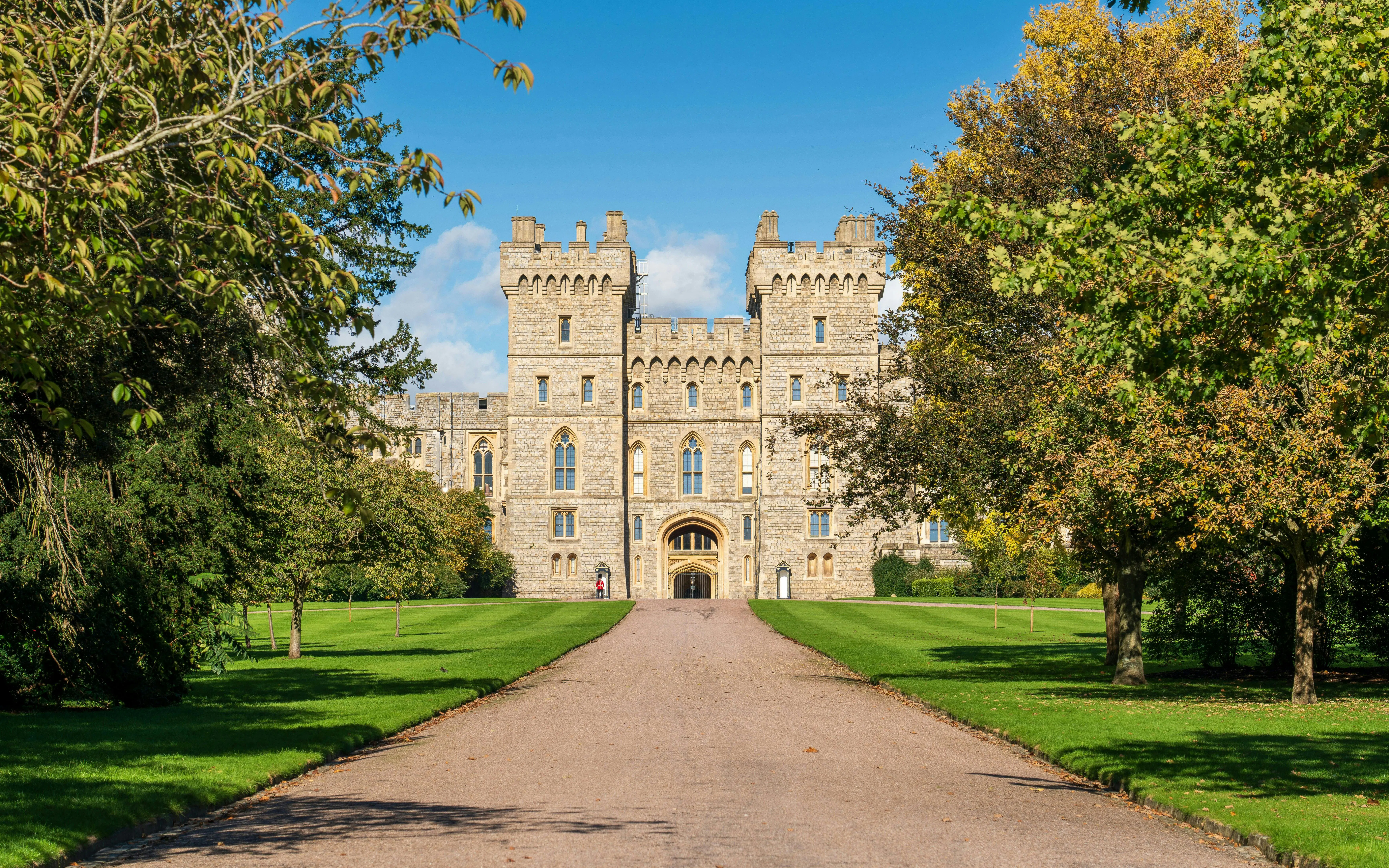 Windsor Castle exterior with stone facade and surrounding greenery.