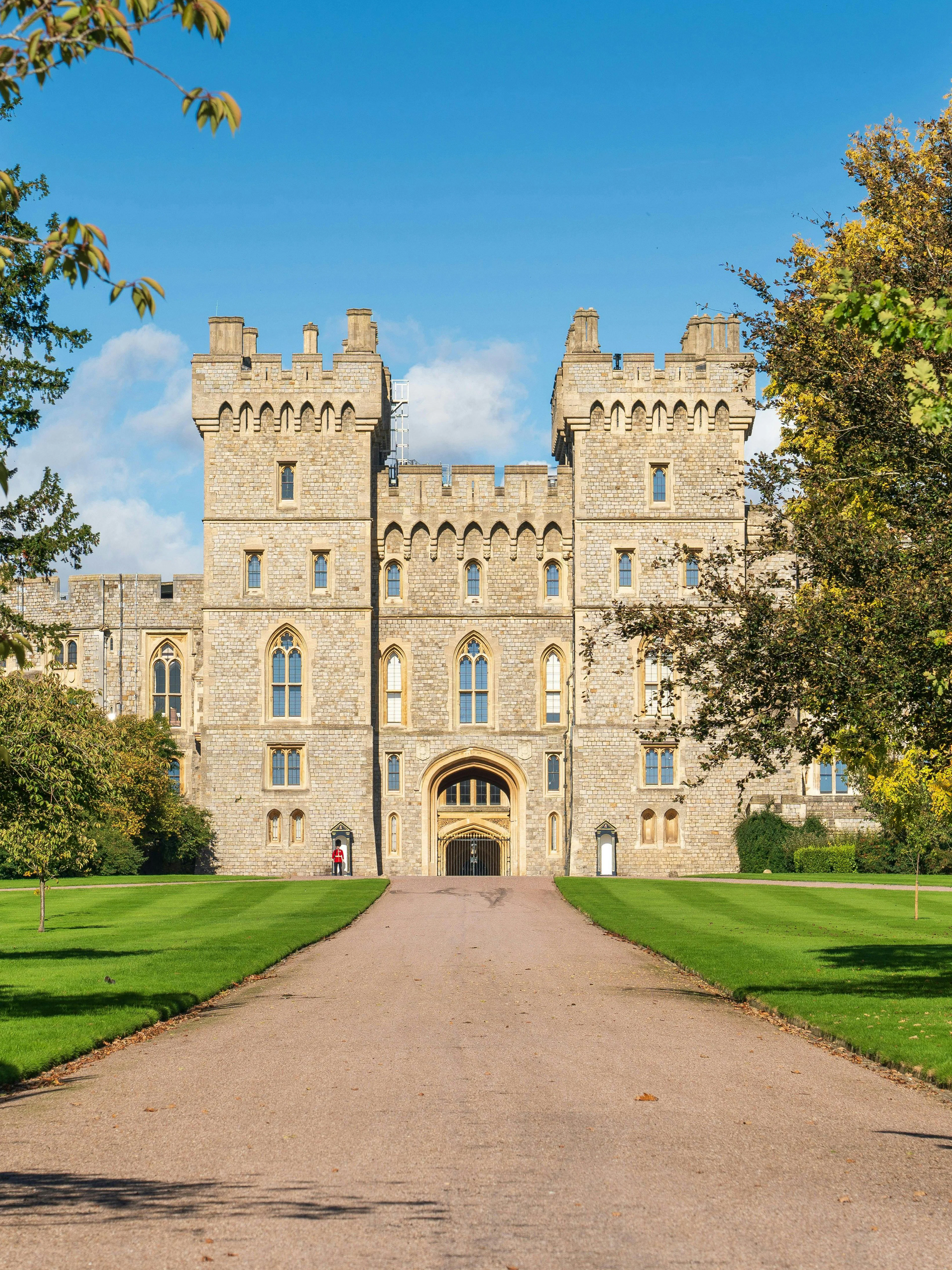 Windsor Castle exterior with stone facade and surrounding greenery.
