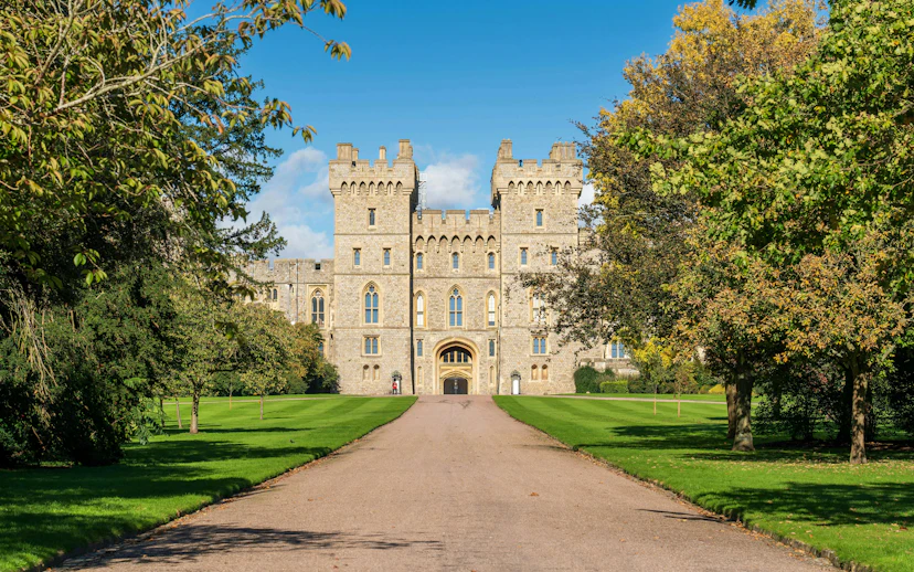 Windsor Castle exterior with stone facade and surrounding greenery.