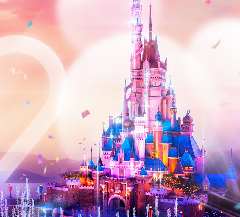 Hong Kong Disneyland castle with colorful fireworks in the night sky.