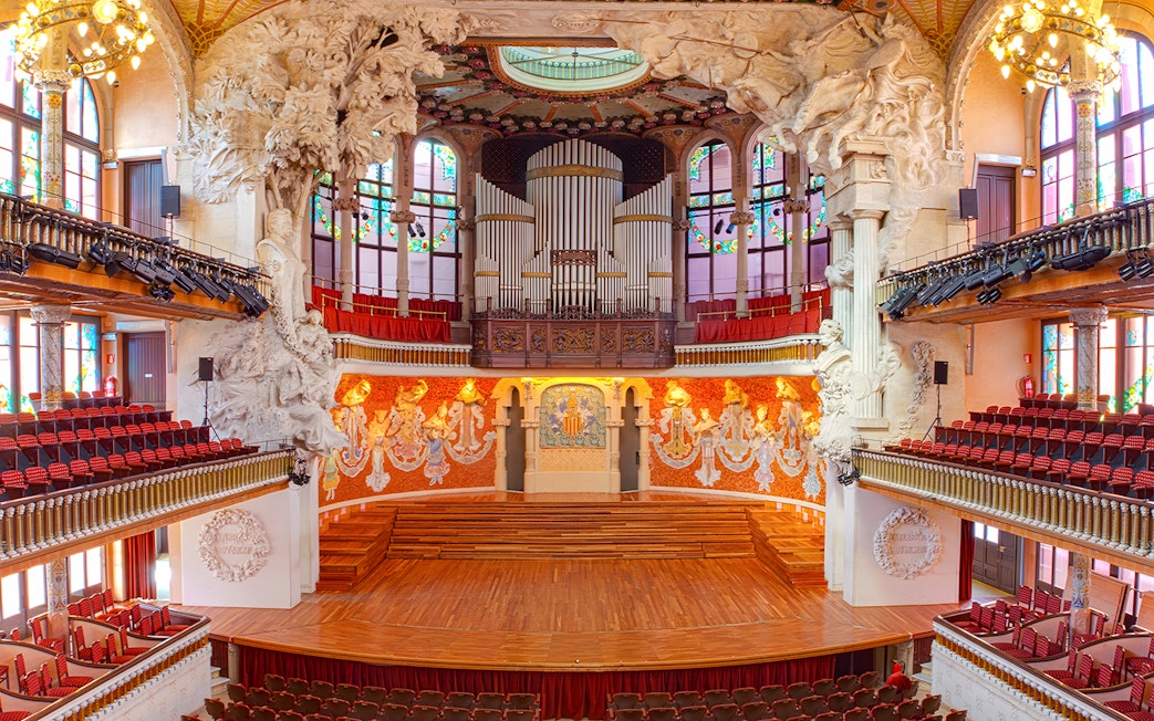 Palau de la Música Catalana concert hall interior with ornate stage and organ in Barcelona.
