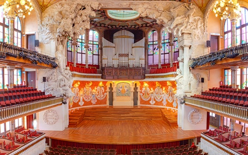 Palau de la Música Catalana concert hall interior with ornate stage and organ in Barcelona.