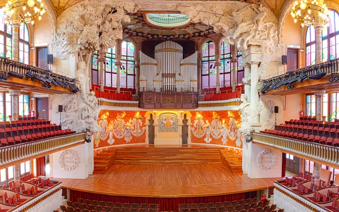Palau de la Música Catalana concert hall interior with ornate stage and organ in Barcelona.