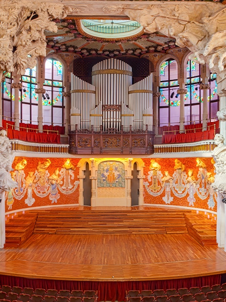 Palau de la Música Catalana concert hall interior with ornate stage and organ in Barcelona.
