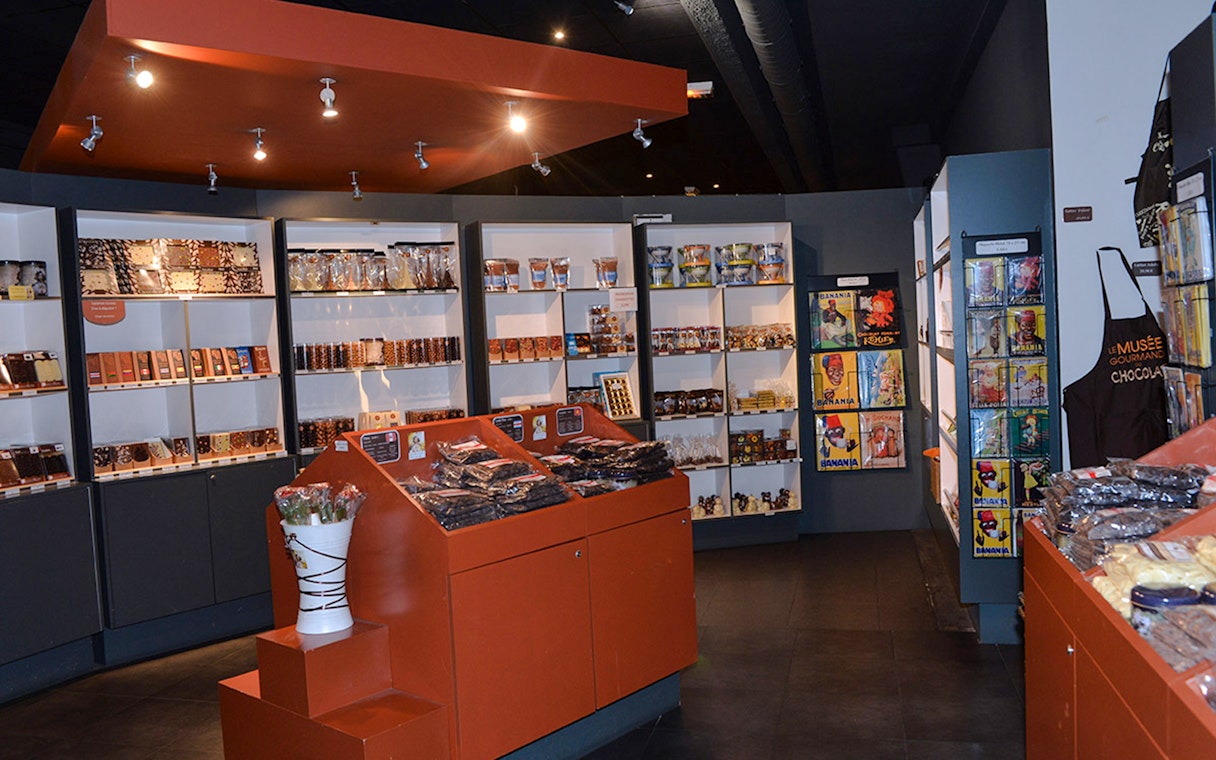 Choco-Story Paris interior with chocolate displays and merchandise shelves.