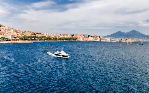 Ferry crossing the Gulf of Naples with Mount Vesuvius in the background.